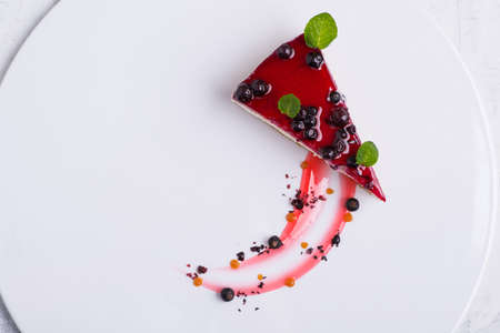 delicious cake with berries on a white plateの写真素材