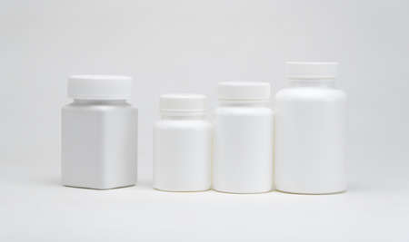 White plastic pill jars on a white background. Isolatedの写真素材