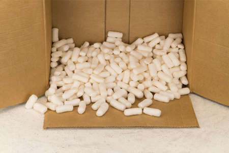 Empty cardboard box with polystyrene filler for safe packaging. Top view
