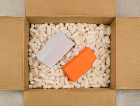 Empty cardboard box with polystyrene filler for safe packaging. Top view