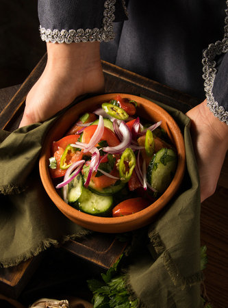 A shot of a person putting dishes on the tableの写真素材