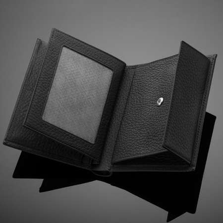 A closeup of a fashionable leather wallet on a dark background