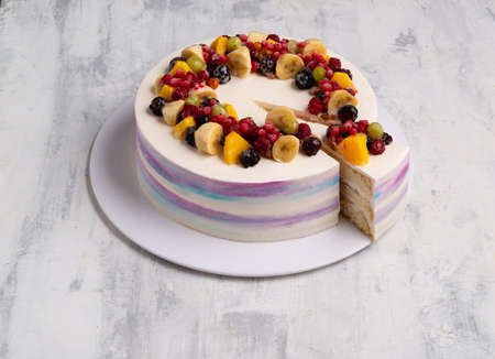 A top view shot of a fruit cake on a white plateの写真素材