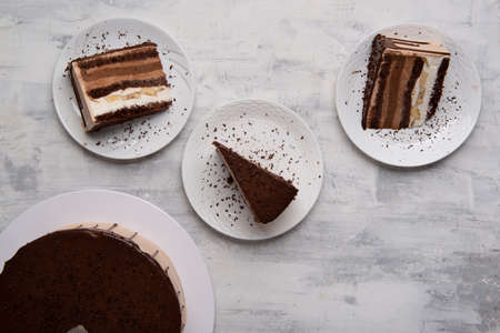 A top view shot of chocolate cake slices on a white plates.