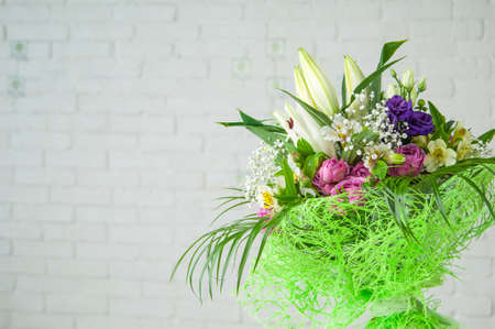 A beautiful bouquet with peony roses, lisianthus, and alstroemeria isolated on a white backgroundの写真素材