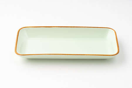 A ceramic green rectangular plate isolated on white backgroundの写真素材