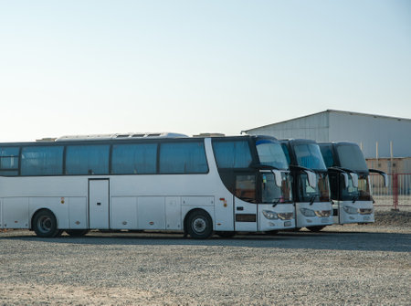A passenger shift buses stand in a row on a construction siteの写真素材