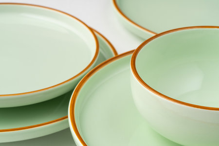 A set of pastel green ceramic tableware with orange outlinesの写真素材