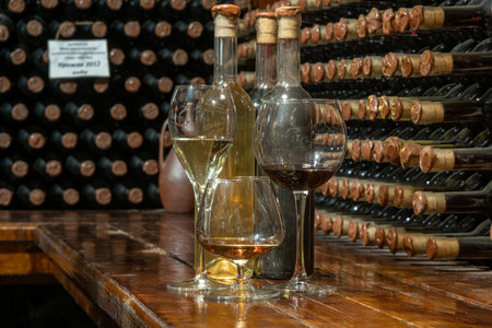 A closeup of bottles of different types of wine with a wine cellar in the background. wine tastingの写真素材