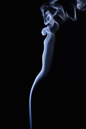 A vertical shot of blue tobacco smoke on a black backgroundの写真素材