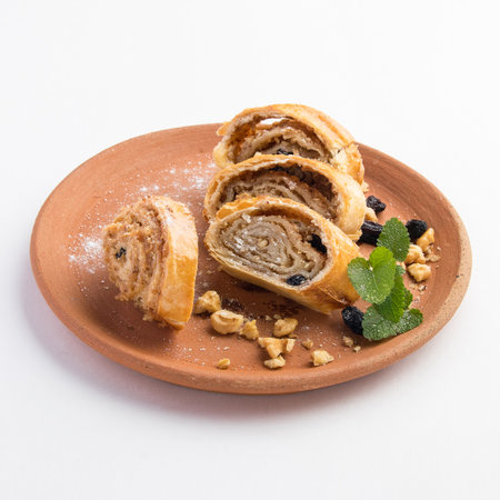 A beautiful shot of tasty sweet rolls with walnuts, raisins and sugarの写真素材
