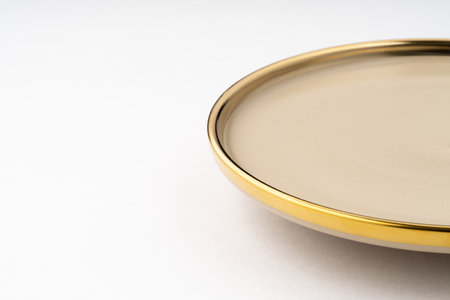 A light brown ceramic plate on a white background. close-upの写真素材