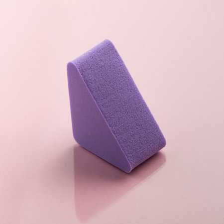 Purple cosmetic sponge on pink backgroundの写真素材