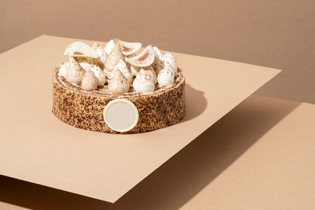 A scrumptious desert plate featuring a meringue desert, served on a cardboard plate and topped with creamの写真素材
