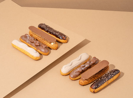 A set of delicious glazed donuts in a variety of flavors, arranged on a cardboard paper in an...