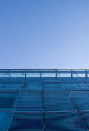 Clouds reflected in windows of modern office building.の写真素材