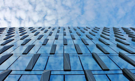 Clouds reflected in windows of modern office building