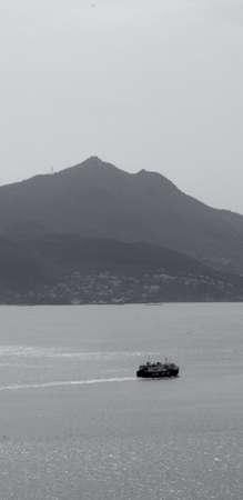 ferry boat in the sea with island in the background.のeditorial素材
