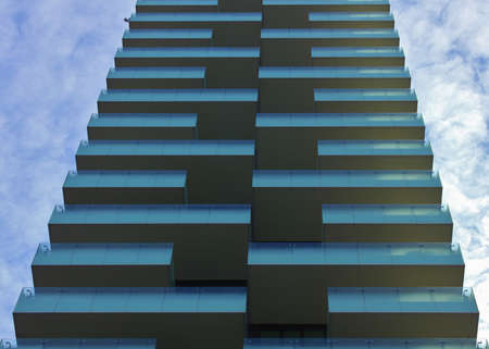 Glass facade of a skyscraper in milan city center with blue glass panelsのeditorial素材