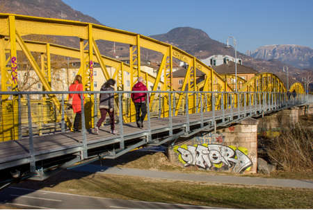 Peaple walking on pedestrian and cycle  yellow steel bridge with mountain.のeditorial素材
