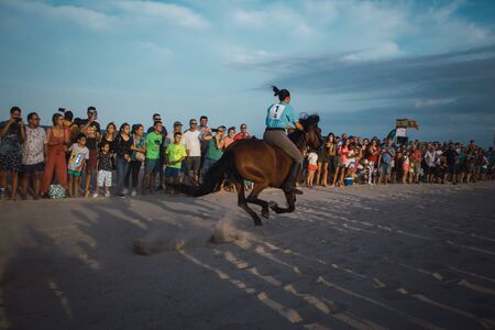 Photo of a girl on a horse in the beachの写真素材