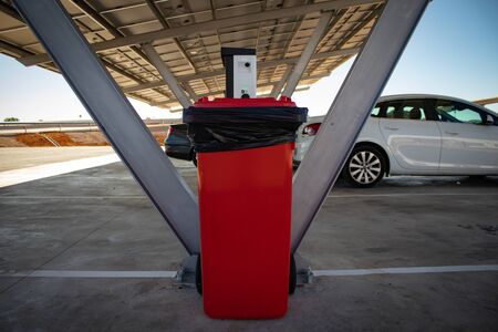 Photo of a rubbish bin in a parking