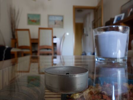 Photo of a cadle with a blurred candle in the interior of a houseの写真素材