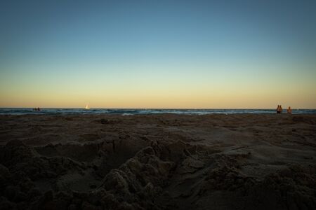 Photo of sand in the beach with the sea in the backgroundの写真素材