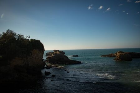Photo of rocks in the blue seaの写真素材
