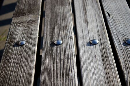 Photo of wooden tables with nailsの写真素材