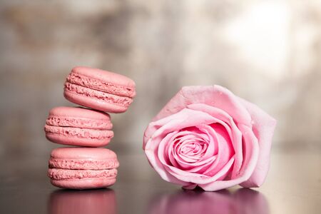 Pink macaroons, delicious French pastries and one pink rose の写真素材