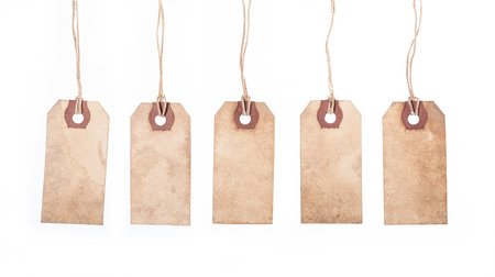 Assortment of vintage tags and labels with texture and stain details White backgroundの写真素材