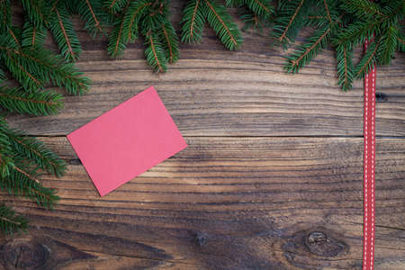 Pine tree with red ribbon on old wooden backgroundの写真素材