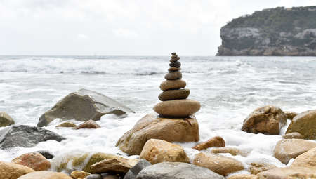 a tower of stones on the seaの写真素材