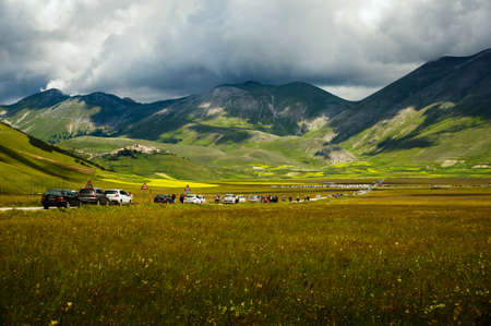 Castelluccio di Norcia, Umbria, Italy - June 21, 2020: beginning of flowering around Castelluccio di Norcia (June 2020): fields in lavish color, with red poppies, yellow rapeseed and other flowers.のeditorial素材