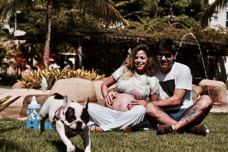 Pregnant woman with husband and dog in natureのeditorial素材