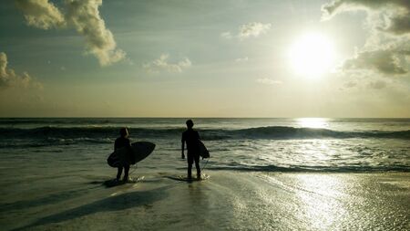 Two surfers waiting to get into the waterの写真素材