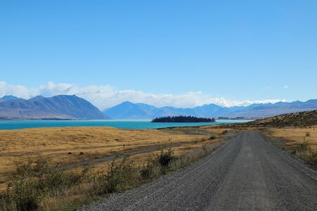 Solitary road with a colourful landscapeの写真素材