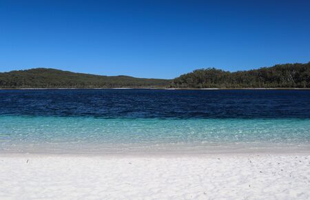 Transparent blue water on an empty and solitary beachの写真素材