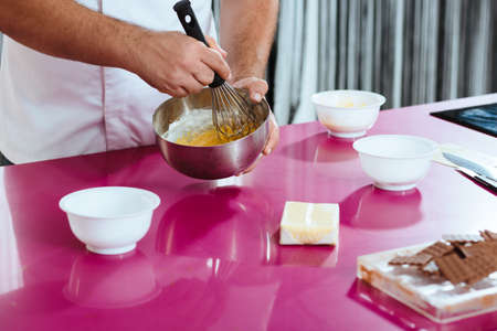Pastry chef using chocolate for his dessertsの写真素材