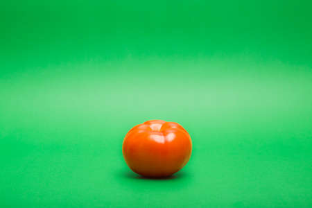 Fresh tomato on green backgroundの写真素材