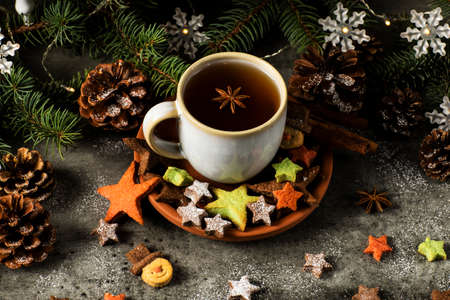 Hot tea with Christmas cookies, star and snowman shape. Decorated for the holidays season