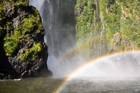 Rainbow over the Milford Sound waterfall. New Zealandの写真素材