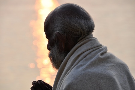 Sadhu praying at the ghats in Varanasi  India のeditorial素材