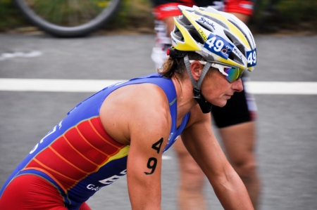 Female athlete competing in the cycling section of the Long Distance Triathlon World Championships, July 29, 2012 in Vitoria Gasteiz, Basque Country, Spainのeditorial素材