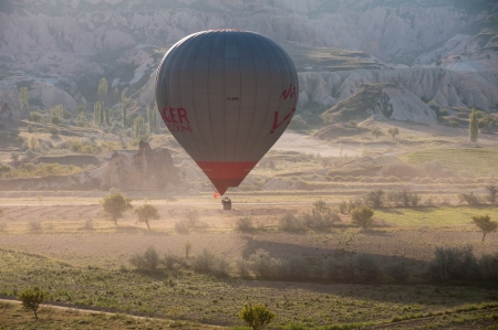 Hot air balloon flies over Cappadocia, the best attraction for tourists, on April 30, 2013 in Cappadocia, Turkeyのeditorial素材