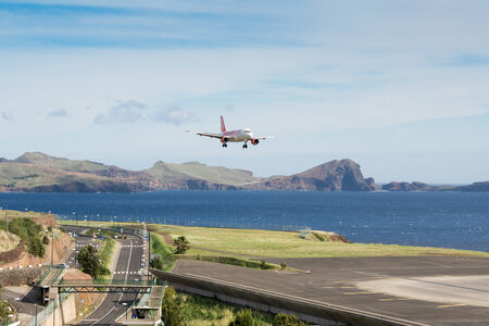 Passenger plane from airline easyJet approaches to Funchal Airport on November 13, 2014 at Madeira, Portugalのeditorial素材