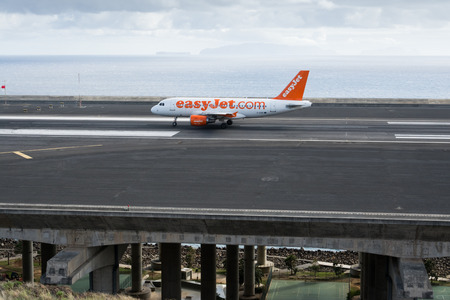 Passenger plane from airline easyJet prepares for take off from Funchal Airport on November 13, 2014 at Madeira, Portugalのeditorial素材