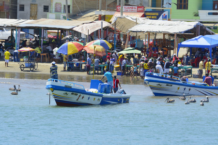 A traditional fish market on the beach on September 3, 2014 in Puerto Lopez, Ecuadorのeditorial素材