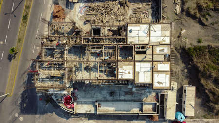 Aerial top view of a construction site on the sixth month with workers and heavy machinery.の写真素材